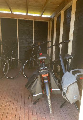 a group of bikes parked in a garage at Kerkhotel Bij De Pastorie in Reitsum