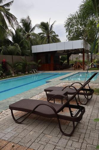 a couple of benches next to a swimming pool at Solcuerpo in Dauin