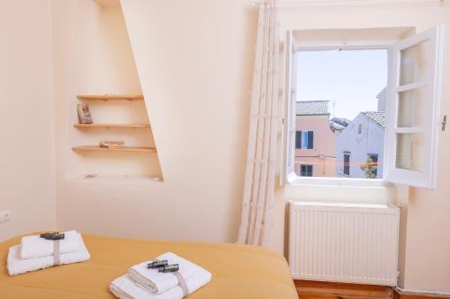 a bedroom with a bed and a window at Mouragia Budget Places in Corfu Town