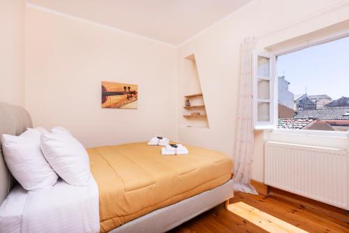 a bedroom with a bed and a window at Mouragia Budget Places in Corfu Town