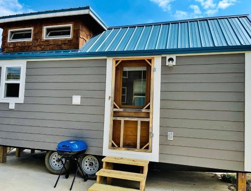 a tiny house with a blue roof at Mountain Roots in Newport