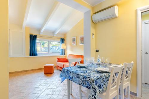 a dining room with a table and chairs at Hostdomus - Sunflower Suite in Alassio