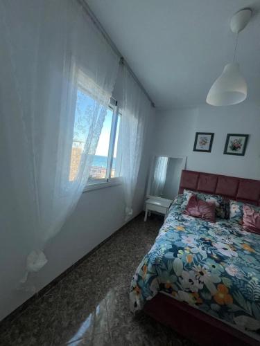 a bedroom with a bed and a window at oued laou Mekkad in Oued Laou