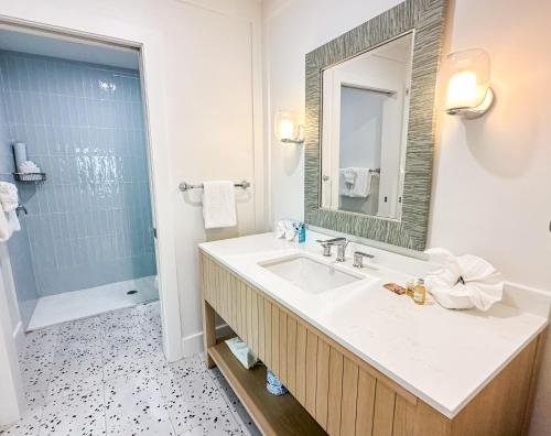 a bathroom with a sink and a shower at Lighthouse Resort: Inn & Suites in Fort Myers Beach