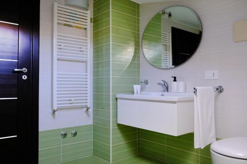 a bathroom with a sink and a mirror at Andrea's House in Locri