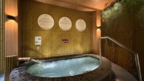 a jacuzzi tub in a room with signs on the wall at Flamingo Hai Tien in Hoằng Hóa