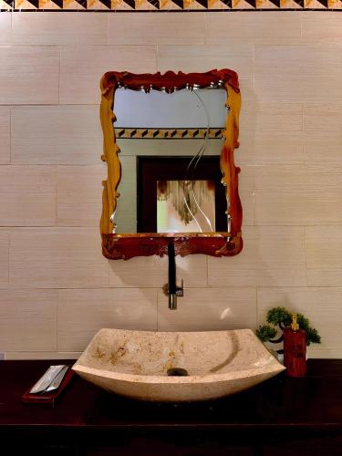 a bathroom with a sink and a mirror at Meket Bungalows in Nusa Penida