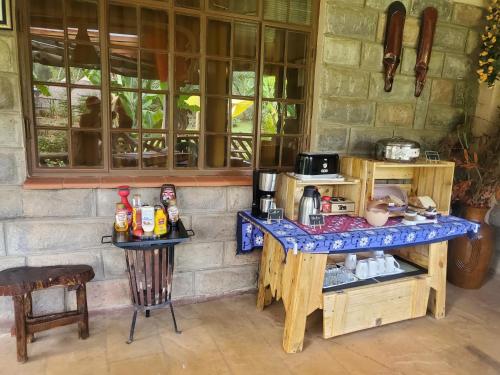 a kitchen with a table with a counter top at Edaala Comfort - B&B in Nairobi