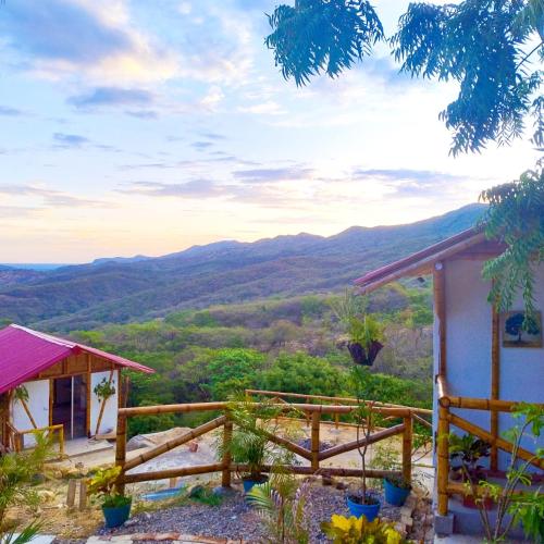 a house with a view of the mountains at El Eden Glamping cabañas Girardot in Girardot