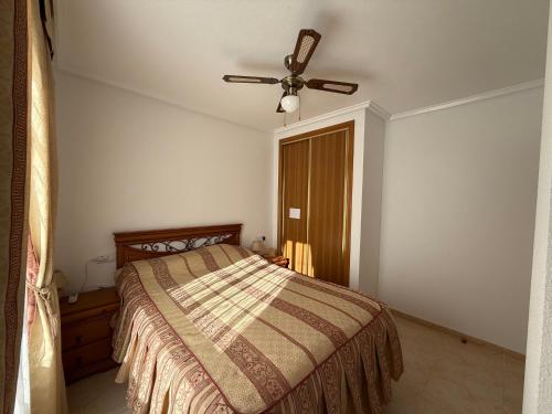 a bedroom with a bed and a ceiling fan at Apartment in Strandnähe in Guardamar del Segura
