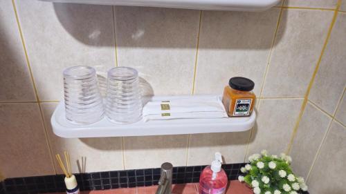 a shelf above a sink with stacks of plates at Rawai Naiharn 3 bedroom house in Rawai Beach