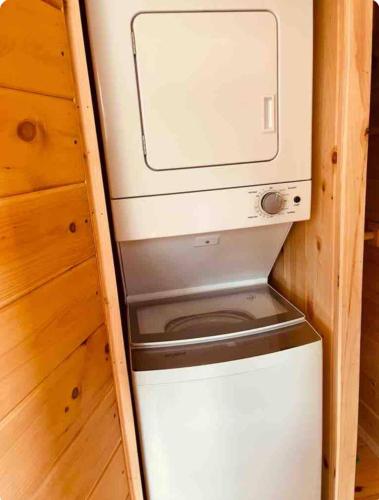 a refrigerator with a washer and dryer in a room at Mountain Roots in Newport