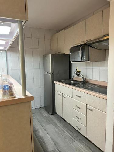 a kitchen with a stainless steel refrigerator and a sink at Suites Arquimedes 33 in Mexico City