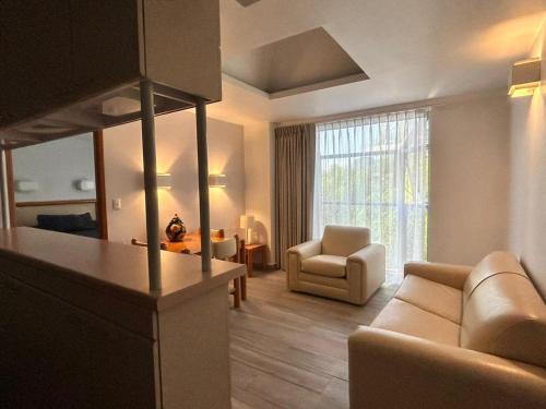 a living room with a couch and a chair at Suites Arquimedes 33 in Mexico City