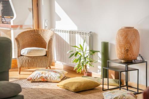 a living room with two chairs and a rug at Nativo Sea Garden in Nazaré