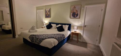 a bedroom with a large bed with pillows at Spacious Colchester Home with Off-Street Parking for 4 cars in Colchester