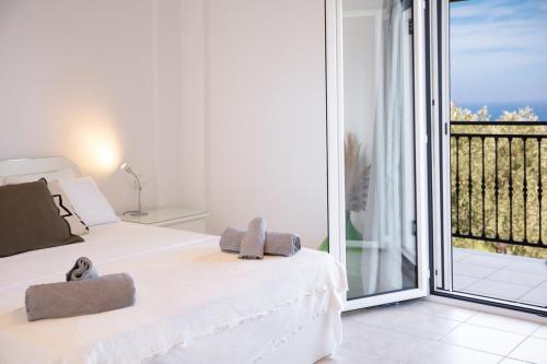 a bedroom with a bed with two towels on it at Petralia's Apartment in Skiathos National Airport