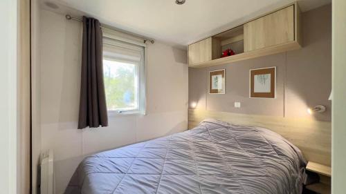 une petite chambre avec un lit et une fenêtre dans l'établissement Erbarie43, à Fréjus