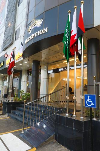 a group of flags in front of a building at الفخامه بارك in Şabyā