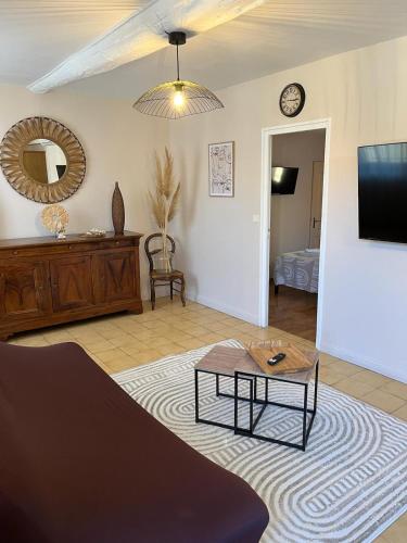 - un salon avec une table basse et un miroir dans l'établissement Le Luxembourg, à Narbonne