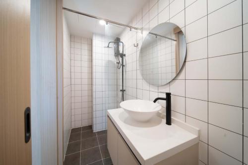 a white bathroom with a sink and a mirror at now condo near beach 2bedroom in Kamala Beach