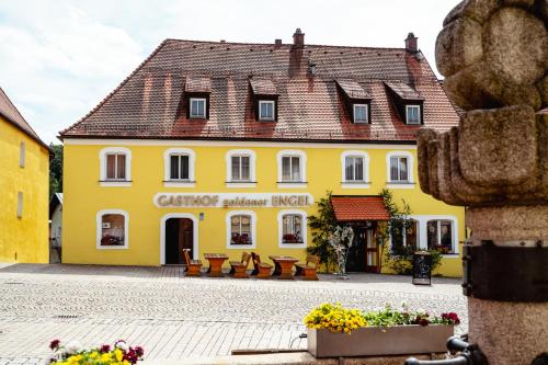 a yellow building in the center of a town at Gasthof goldener Engel in Kemnath