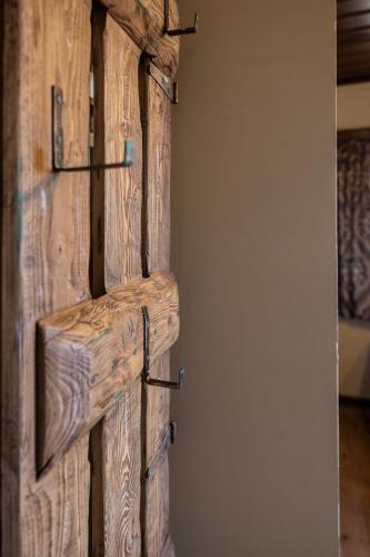 a sliding barn door with hooks on it at Matzato in Monodendri