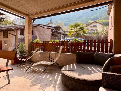 a patio with a couch and chairs on a balcony at Ferienwohnung Julian in Termeno