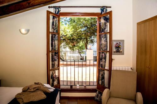 a room with a door open to a balcony at Hotel Torre San Juan in San Juan de Alicante