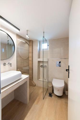 a bathroom with a white sink and a toilet at Annas Apartment Kalithea in Kallithea Halkidikis
