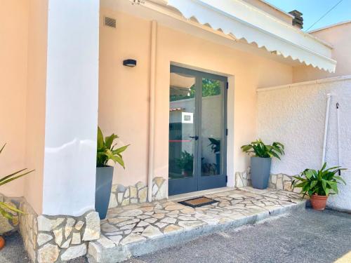 a front door of a house with potted plants at B&B Costa Azzurra in Porto Cesareo