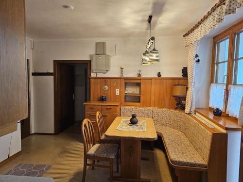 a kitchen with a table and a table and chairs at Apartment Ad Alta Matschiedl 2 in Matschiedl
