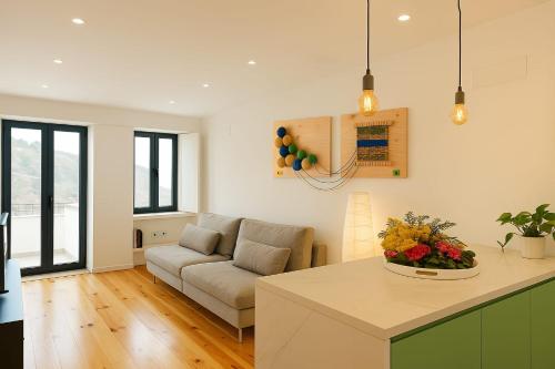 a living room with a couch and a table at Modern Retreat with Mountain Views in Covilhã