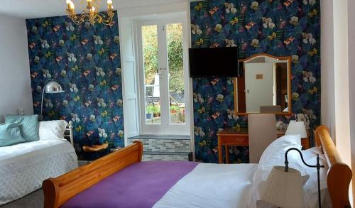 a bedroom with a bed and a mirror at Kings' House in Douglas