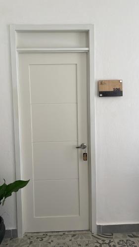 a white door with a sign on top of it at Hotel Boutique Brisas Colonial in Santo Domingo