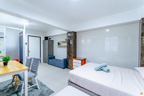 a bedroom with a bed and a desk and a table at Spacious Family Getaway for Big Groups in Lapu Lapu City