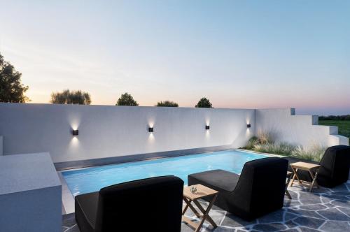 a swimming pool in the middle of a patio at Magia's Residence in Naousa
