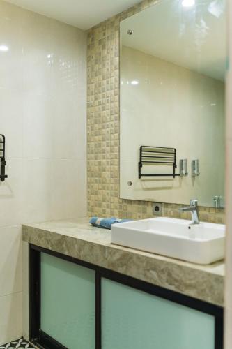 a bathroom with a sink and a mirror at 3BR Pool Villa, Canggu, River View in Dalung