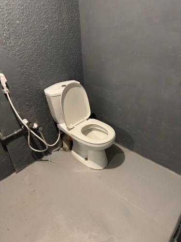 a bathroom with a white toilet in a stall at Moonlight surf hostel in Arugam Bay