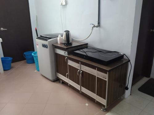 a kitchen with a sink and a phone on a counter at Hajar Guest House in Kisap