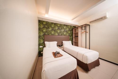Postel nebo postele na pokoji v ubytování The Mesui Hotel Bukit Bintang