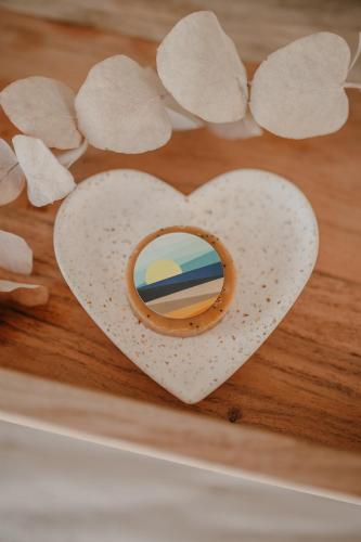 a heart shaped cookie on a wooden cutting board at La Villa de Pen ar Menez terre & mer avec spa in Plouider