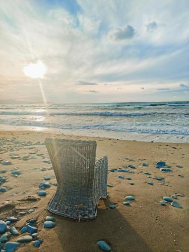 a shopping basket sitting on a beach with rocks at Villa Best Holiday- breathtaking sea views, amazing garden, private pool, BBQ, next to CORAL BAY, Lower Peyia, Paphos in Peyia