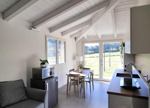 a kitchen and living room with a couch and a table at Colle Gelso in Cesena