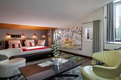a bedroom with a bed and a table and chairs at Maison Lavaud in Paris