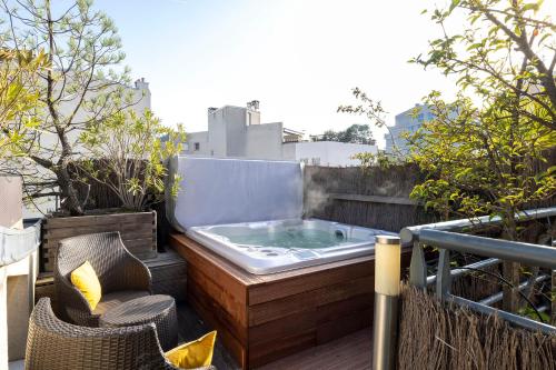 a jacuzzi tub sitting on top of a balcony at Maison Lavaud in Paris