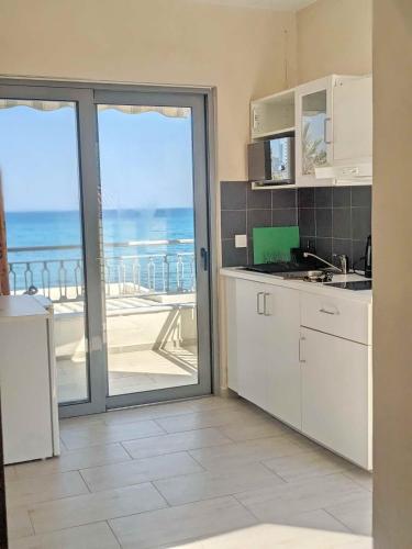 a kitchen with a view of the ocean at Panorama Inn in Lithakia