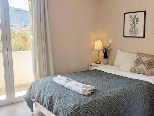 a bedroom with a bed with two towels on it at Panorama Inn in Lithakia