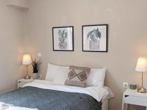 a bedroom with a bed with three pictures on the wall at Panorama Inn in Lithakia