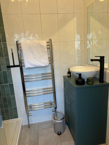 a bathroom with a sink and a mirror at Church Mouse Cottage Clitheroe in Clitheroe
